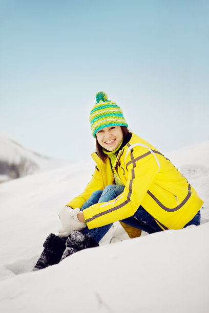 女性在户外玩雪在冬天的衣服图片下载