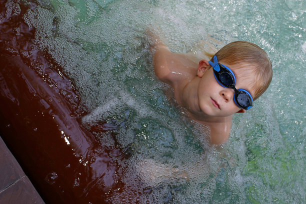 在室外热水浴缸里的男孩图片下载
