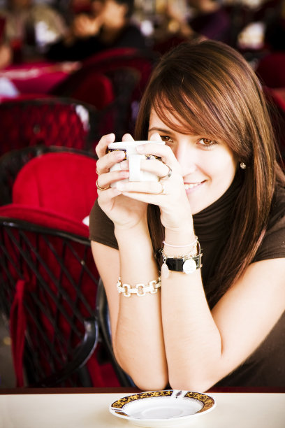 拿着一杯咖啡微笑着的女人图片下载