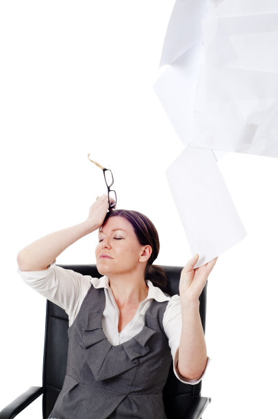 职场女性在办公桌前把纸抛向空中图片下载