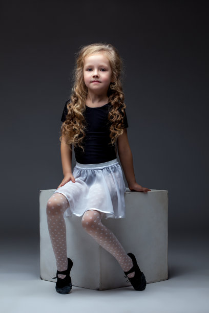 迷人的卷发演员在工作室摆姿势图片下载