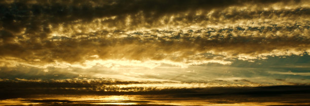 戏剧性的日落，金色的云在傍晚的天空图片下载