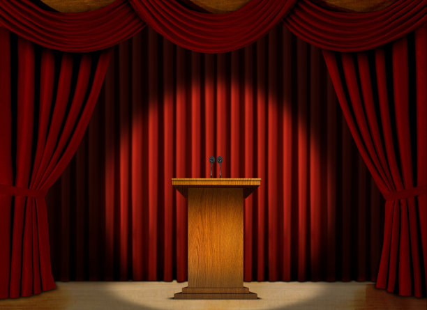 舞台上的红幕聚光灯下的讲台图片下载