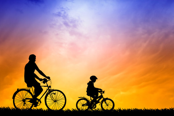 父亲和儿子在夕阳下骑自行车图片下载