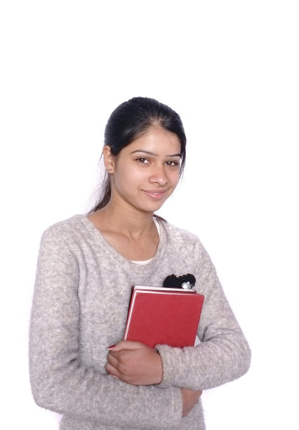 一个女学生的肖像拿着书在白色。图片下载