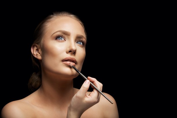 有魅力的女人在涂唇彩图片下载