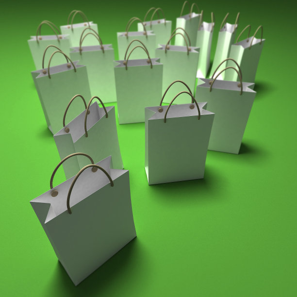 绿色背景下的白色购物袋图片下载