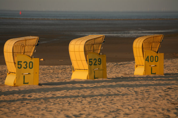 北海海岸的三张黄色沙滩椅图片下载