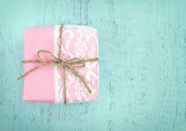 白色蕾丝和一个简单的蝴蝶结在粉色礼盒图片下载