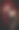 迷人的黑发女人在黑色摆出戏剧性的紫色背景图片下载