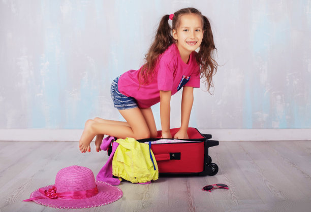 一个穿着短裤和粉色t恤的孩子要去度假。图片下载