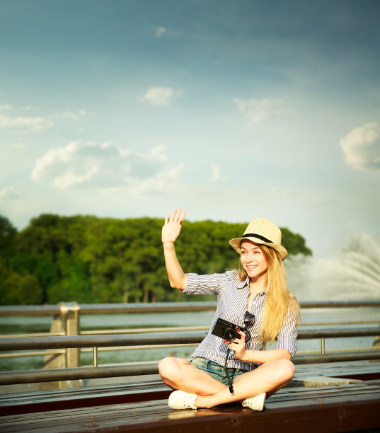 快乐的年轻嬉皮士女孩挥手打招呼图片下载