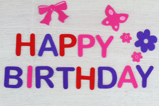白色的木头上用彩色的字母写着生日快乐图片下载