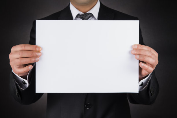 商人藏在一张白纸后面图片下载