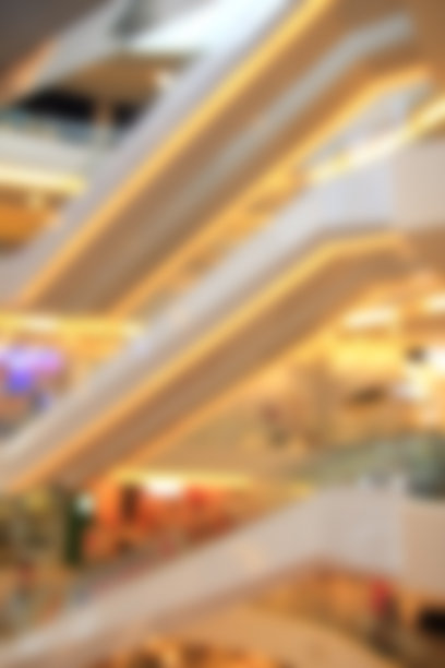 模糊抽象的电梯和人们在购物中心的背景图片下载