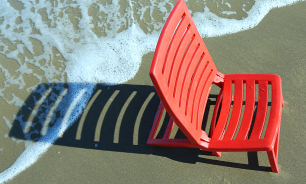 在温暖的日子里坐在海边的沙滩椅上图片下载
