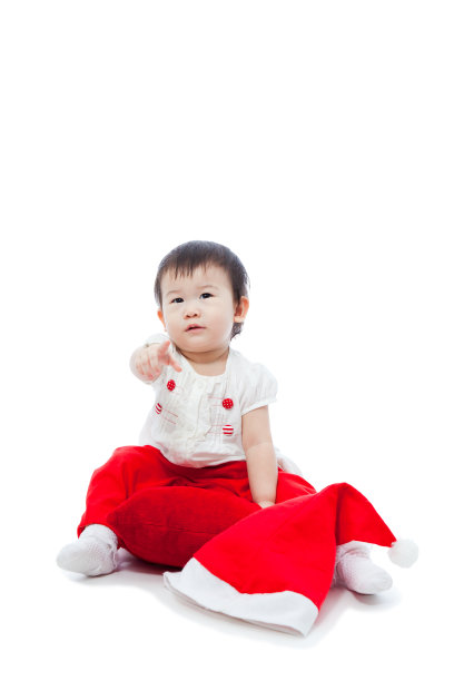 快乐的圣诞女孩坐着指指点点图片下载