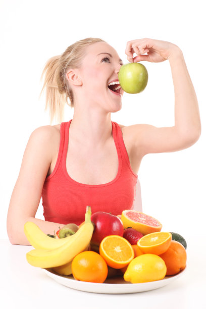 年轻美丽的女子与青苹果。图片下载