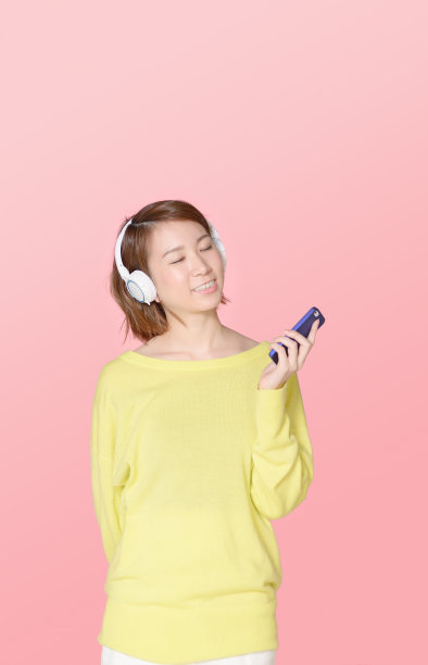 年轻女子戴着耳机听音乐图片下载