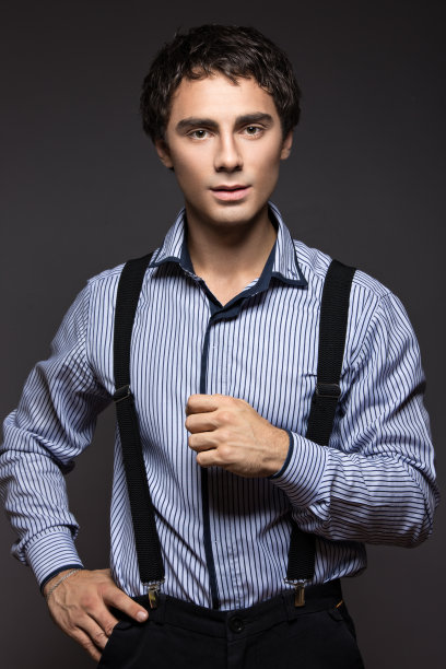 严肃的年轻人，穿着带背带的条纹衬衫。商务风格。图片下载