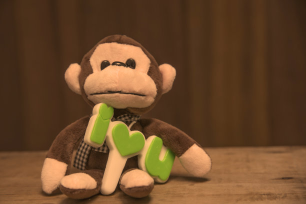 爱的标志与模糊的猴子娃娃。图片下载