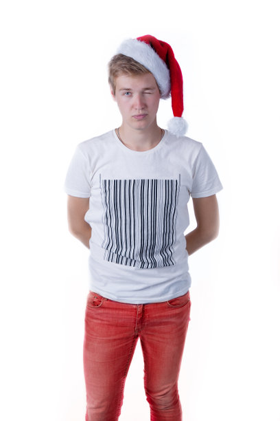 戴着圣诞老人帽子的闷闷不乐的男孩图片下载