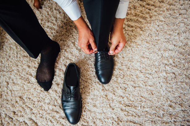 近景年轻男子系优雅的鞋在室内图片下载