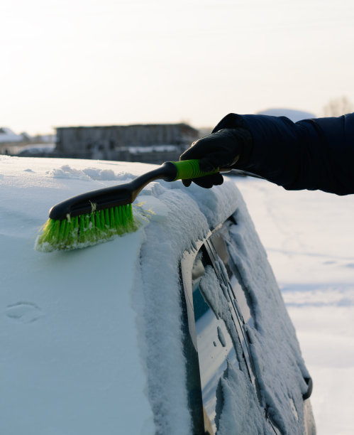 年轻人清理车上的雪图片下载