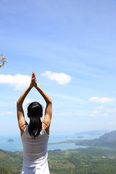 年轻女子在山顶练习瑜伽图片下载