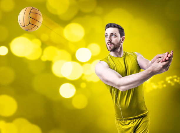 黄色背景上穿黄色队服的排球运动员图片下载