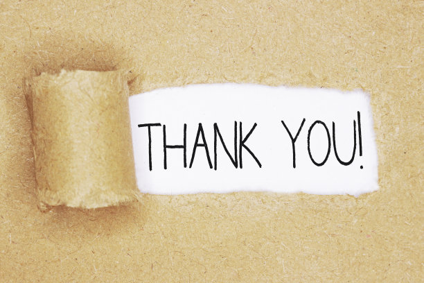 写着“谢谢”的撕好的牛皮纸素材图片