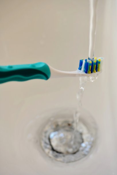 在水龙头下牙刷图片下载