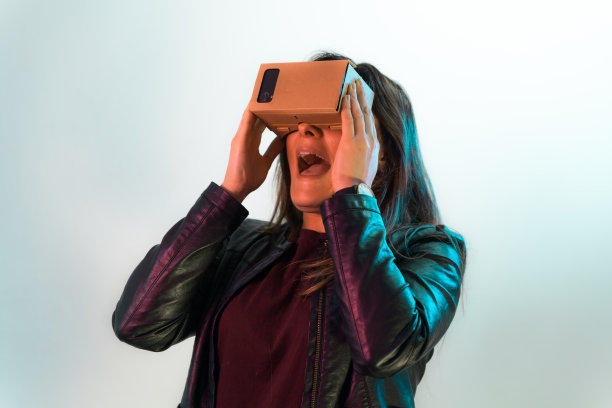 年轻害怕的女孩尝试虚拟现实纸板耳机图片下载