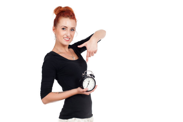 漂亮的红发女人拿着个钟，图片下载