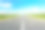 柏油路在绿色的田野上，在蓝色多云的天空背景下素材图片