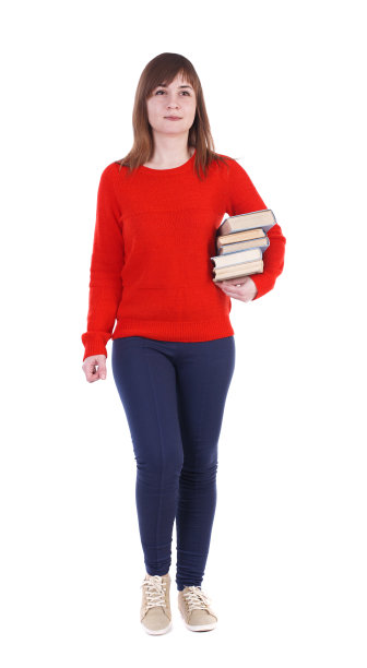 女孩带着一堆书来了。前视图。图片下载