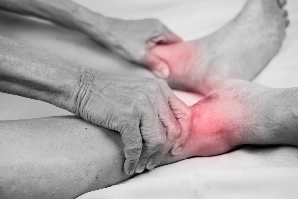 男人的手牵着他健康的脚，按摩脚踝图片下载