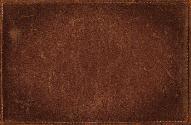 棕色垃圾背景从窘迫皮革纹理与缝制框架素材图片