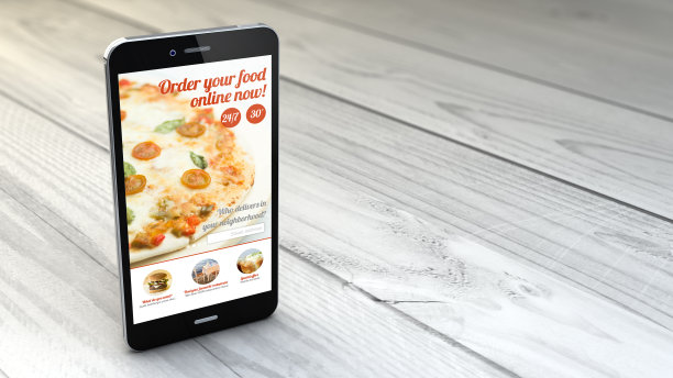 智能手机上的白色木制背景与订购披萨网站图片下载
