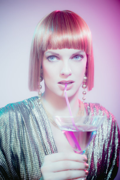 用吸管喝鸡尾酒的红头发女人图片下载