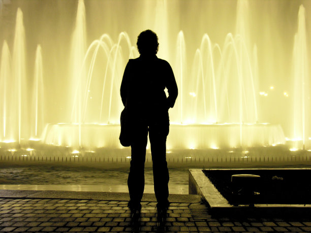 女人侧影看着发光的喷泉图片下载