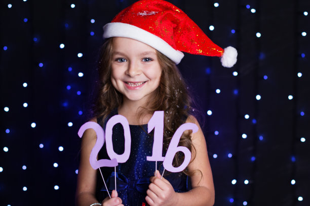 微笑的圣诞女孩与2016年新年日期图片下载