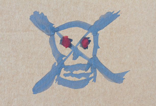 在灰色背景的纸上画骷髅。图片下载