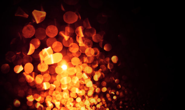 将抽象的金色灯光散焦到黑色上图片下载