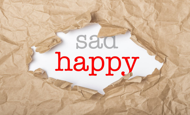 在纸上和破纸盒上写着快乐和悲伤图片下载