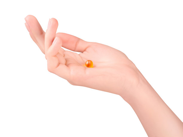 女性手上有橙色药丸图片下载