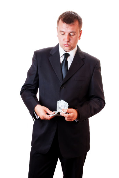 穿着西装手里拿着钱的情绪化男人。图片下载