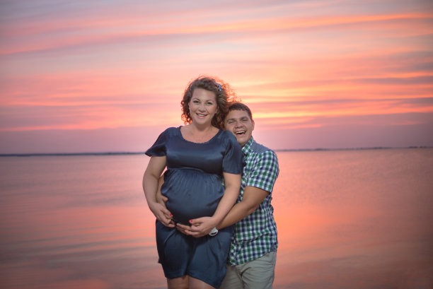 幸福和愉快的夫妇靠近河边日落的背景。图片下载