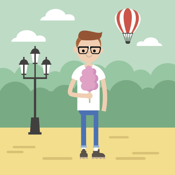 在公园里散步。年轻的书呆子在吃棉花糖图片下载