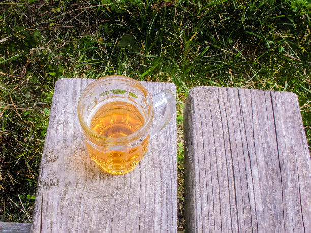 长凳上放着一大杯啤酒图片下载